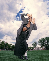 a woman in a skirt and blazer is posing for a photo