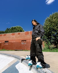 a woman standing on a skateboard in a skate park