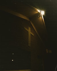 a brick building with a cross on top