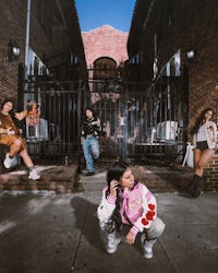 a group of people posing in front of a building