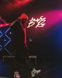 a man in a red hat standing on a stage