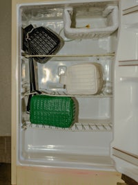 a refrigerator with a lot of purses in it